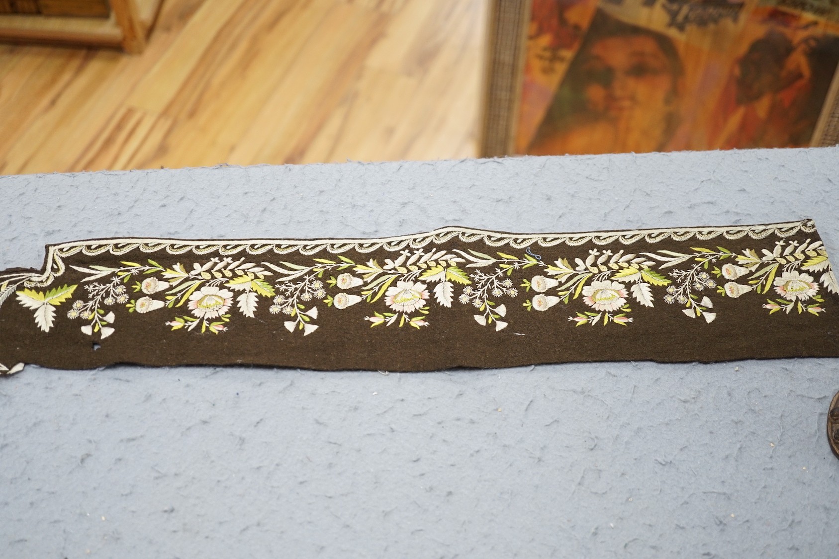 An 18th century embroidered dress front and a similar length of embroidered trimming, together with metallic thread and other later embroidered panels